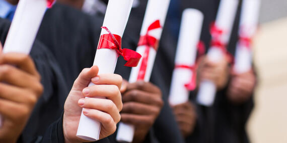 Hands holding diplomas