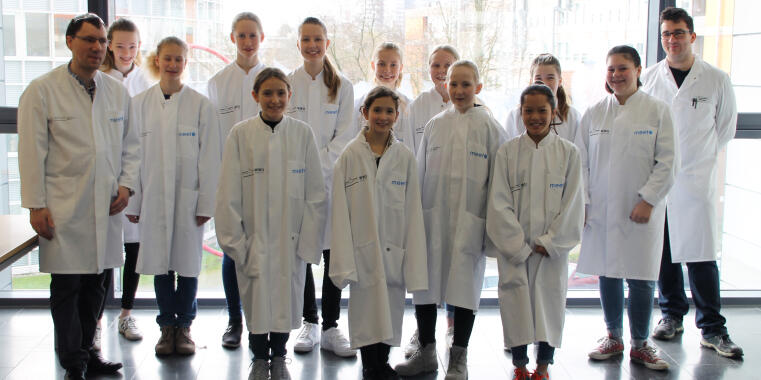 Group picture of the participants of Grils' Day wearing coats 