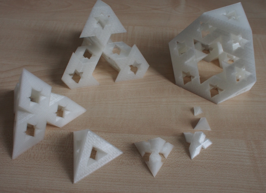A picture of 3D-printed object. There are tetrahedra and truncated tetrahedra shapes with holes