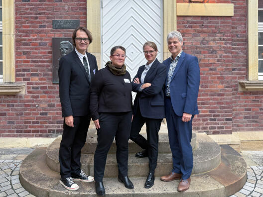 Group photo showing four people