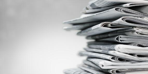 Pile of newspapers on white background