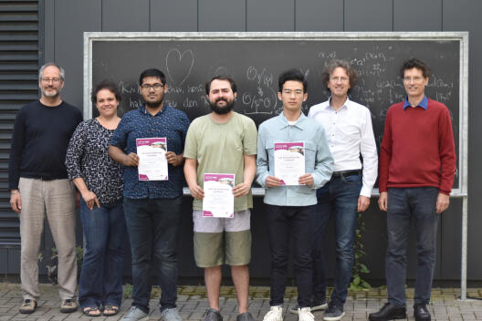 Anupam Datta, Shervin Sorouri and Zhuang Kang, the first full-time master scholarship holders of Mathematics Münster, received their certificates. Prof. Dr. Martin Hils, Dr. Bianca Santoro and Cluster spokespersons Prof. Dr. Mario Ohlberger and Prof. Dr. Christopher Deninger congratulated them on their successful master studies in Münster.