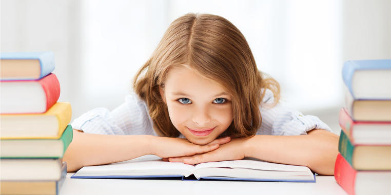 Girl with books at a desk