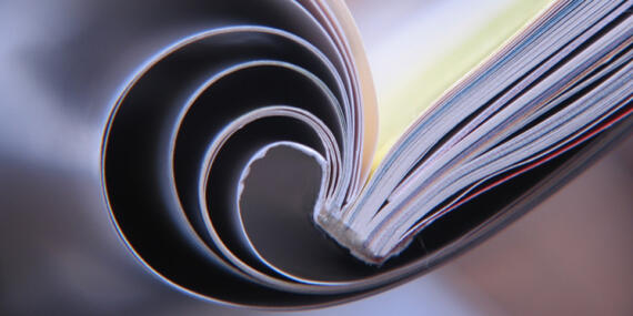 Close view of an open magazin, the pages are wraped around the back.