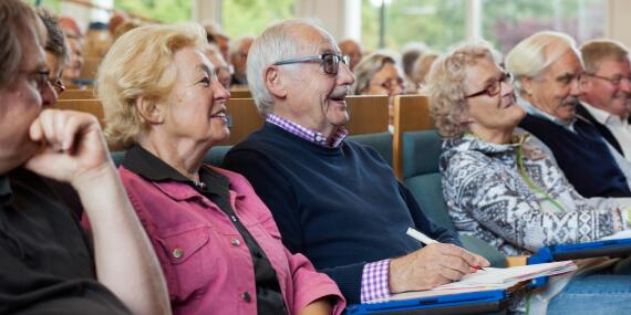 senior citizens entertained by a lecture