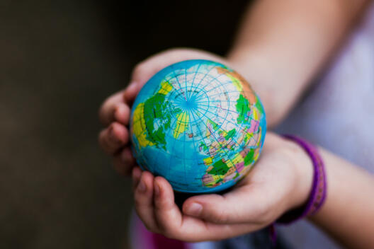 Hands holding a globe