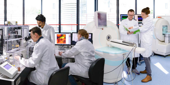 Picture of people working together with different imaging modalities in a laboratory