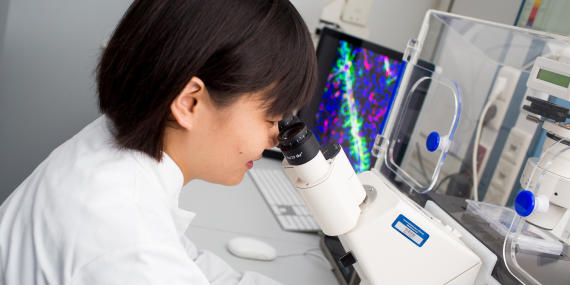 Picture of a scientist working at a microscope