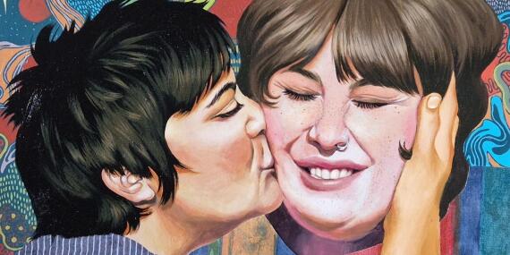 a picture of a person kissing another person on the cheek