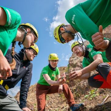 Astronauts and planetary geologists gather around intriguing rocks at the Ries crater in southern Germany.