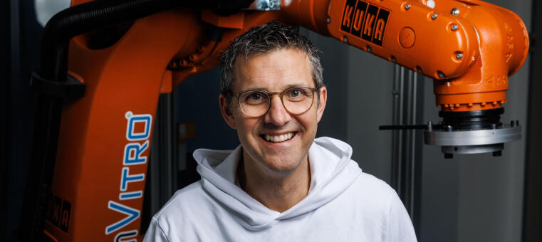Ein Mann sitzt vor einer großen Maschine.