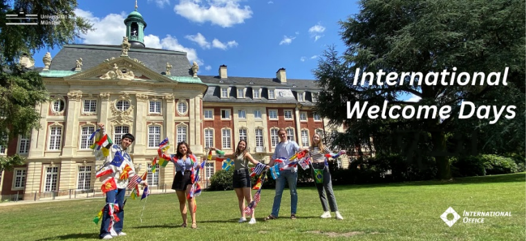 International students with colorful country flags in front of Münster Castle