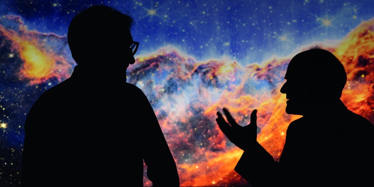 The Science Year 2023 is dedicated to the topic "Our Universe". To mark the occasion, the university newspaper invited physicist Prof. Dr. Kai Schmitz (l.) and philosopher Prof. Dr. Ulrich Krohs to talk about their fascination with the universe and the findings of science. In the background is a projection of a star-forming region in the Carina Nebula. The new James Webb Space Telescope of the space agencies NASA, ESA and CSA took this picture.<address>&copy; WWU - Peter Leßmann/NASA, ESA, CSA, and STScI. Image processing: J. DePasquale (STScI)</address>