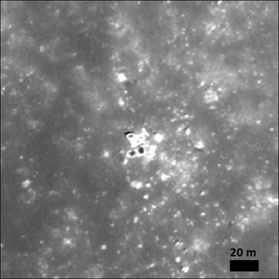 White rocks with unique black spots where dust shows potential magnetic anomalies.<address>© NASA LRO/NAC</address>