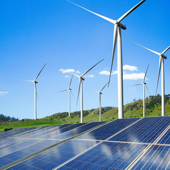 Landscape with wind turbines, solar panels in the foreground<address>© stock.adobe.com - InfiniteFlow (symbolic photo)</address>