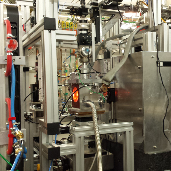 An overview of the experimental setup at DESY in Hamburg reveals the vacuum chamber housing the high-temperature diamond anvil cell. This is installed at the Extreme Conditions beamline. The cell&#039;s orange colour comes from the light it emits at high temperatures.<address>© Carmen Sánchez-Valle</address>