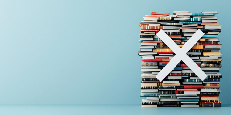 Auf dem Bild sieht man einen Stapel Bücher, davor ein großes weißes X. Diese Komposition soll Bücherverbote symbolisieren.<address>&copy; stock.adobe.com - Weerapat (Generiert mit KI)</address>