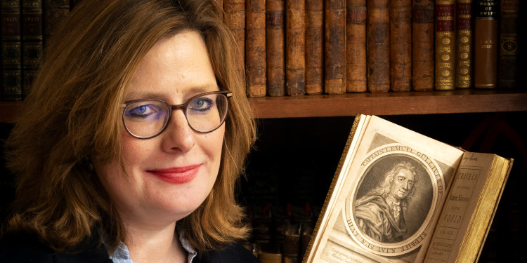 Dr Kirsten Juhas from the English Department presents a copy of one of the first editions of Gulliver’s Travels, published 300 years ago and featuring a frontispiece portrait of the fictional protagonist.<address>&copy; Ehrenpreis Centre / Bischof</address>